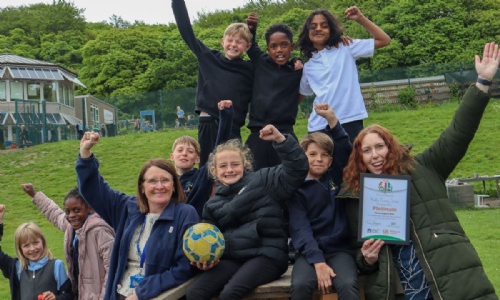 Students and staff at Hady Primary School celebrating with the OPAL Platinum Quality Mark certificate